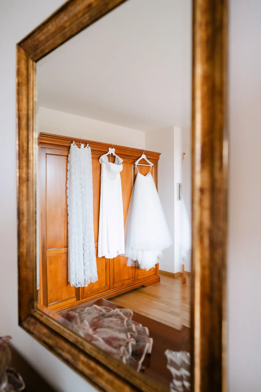 Wedding dresses reflected in a golden mirror
