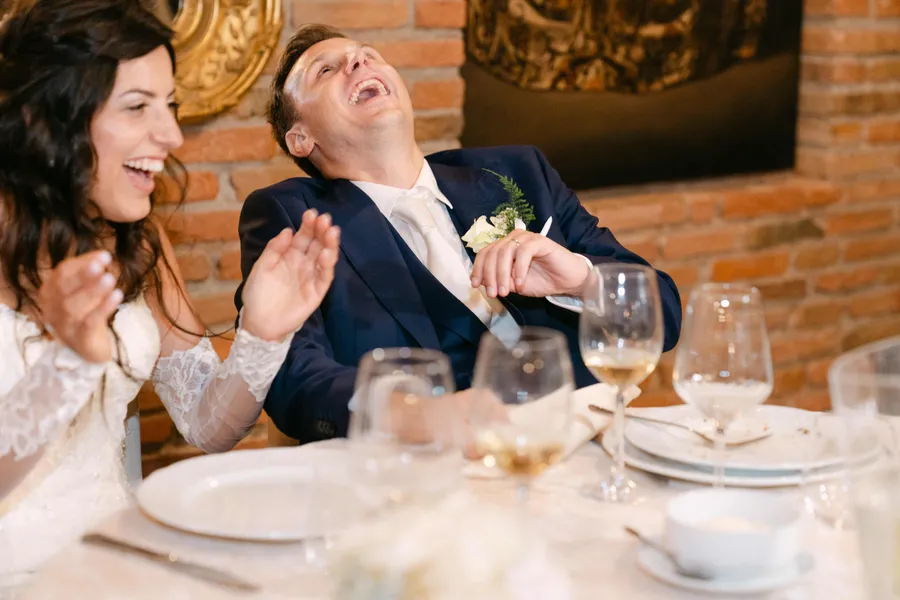Couple laughing together at the reception dinner