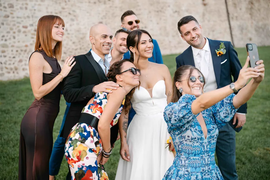 Bride and wedding guests taking a group photo