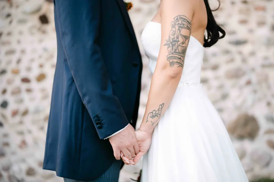 Couple holding hands at wedding ceremony